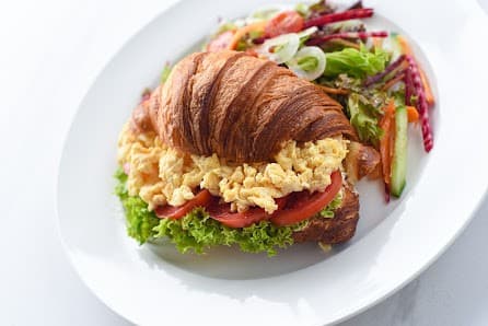 Caramel breakfast plate with croissant and eggs